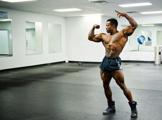 Senior Airman Terrence Ruffin, 16th Electronic Warfare Squadron, practices his posing routine at the fitness center on Eglin Air Force Base, Fla. Ruffin, currently the youngest professional bodybuilder on the circuit at age 22, will compete at the largest bodybuilding competition in the world Sept 17. (U.S. Air Force photo/Samuel King Jr.)