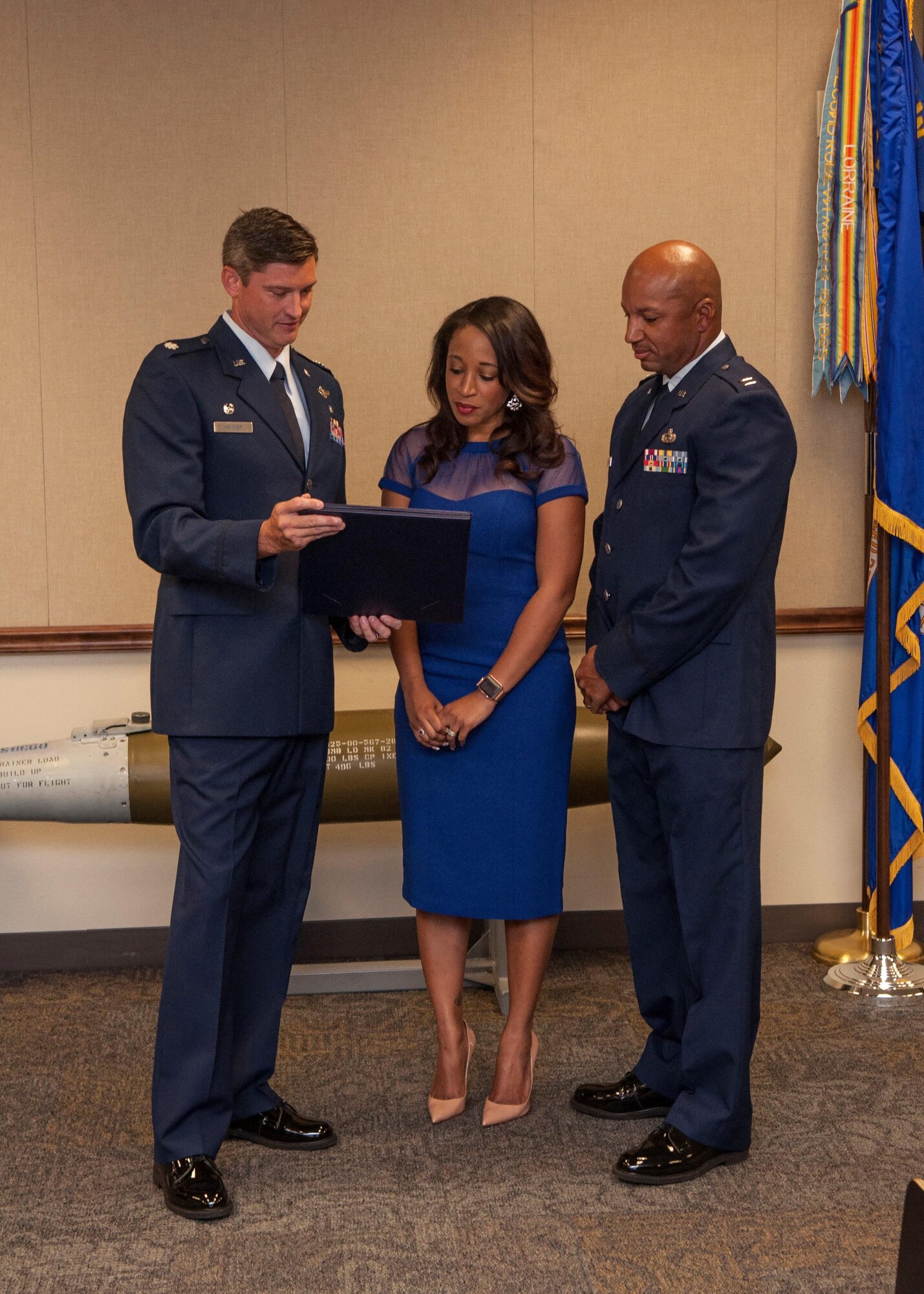 U.S. Air Force Lt Col. Brent Weisner, 93rd Bomb Squadron (BS) commander, presents Felicia Stevens with a spouse’s certificate of appreciation during Capt. Craig Stevens’ retirement ceremony on Sept. 10, 2016, at Barksdale Air Force Base, La.  Stevens is the executive officer for the 93rd BS and is retiring after serving more than 25 years in the military. (U.S. Air Force photo by Tech. Sgt. Cody Burt/Released)