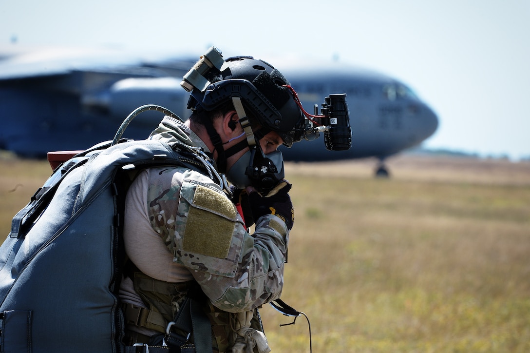 An Air Force pararescueman adjusts his high-altitude training mask before participating in a training jump over Francis S. Gabreski Air National Guard Base in Westhampton Beach, N.Y., Aug. 31, 2016. Air National Guard photo by Staff Sgt. Christopher S. Muncy