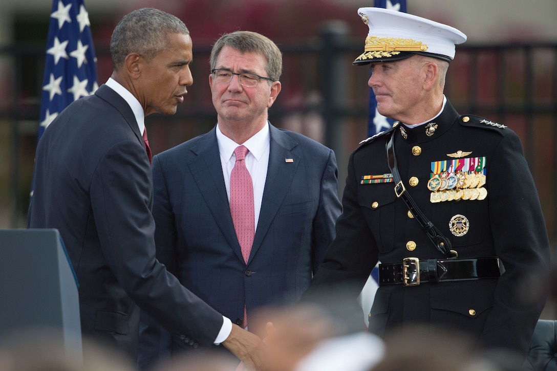 President Barack Obama shakes hands with Marine Corps Gen. Joe Dunford, chairman of the Joint Chiefs of Staff, as Defense Secretary Ash Carter looks on while attending a remembrance ceremony at the National 9/11 Pentagon Memorial, Sept. 11, 2016. DoD photo by Navy Petty Officer 2nd Class Dominique A. Pineiro