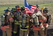 Firemen from the 5th Civil Engineer Squadron huddle up before they start their 9/11 memorial climb at Minot Air Force Base, N.D., Sept. 11, 2016. In honor of the emergency responders who lost their lives in the terrorist attacks of 9/11, the Minot AFB fire department climbed 110 stories, the equivalent of what the twin towers had prior to the attack. (U.S. Air Force photo/Airman 1st Class Christian Sullivan)