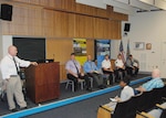 William Bullock, Sr., left, emergency manager, Defense Logistics Agency Installation Support at Richmond, Virginia, answers an employee’s questions about the AtHoc Emergency Notification System during a National Preparedness Month Forum held Sept. 8, 2016, on Defense Supply Center Richmond. 