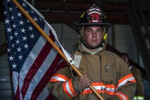 Senior Airman Nickolas Torrez, 5th Civil Engineer Squadron firefighter, leads the way carrying the American flag at Minot Air Force Base, N.D., Sept. 11, 2016. Torrez received this flag while deployed to an undisclosed location from an F-16 pilot that carried out anti-terrorism missions. (U.S. Air Force photo/Airman 1st Class Christian Sullivan)