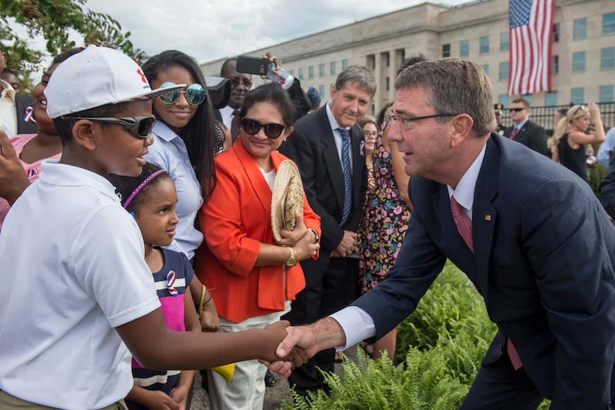Defense Secretary Ash Carter talks with attendees at a ceremony marking the 15th anniversary of the 9/11 attacks.