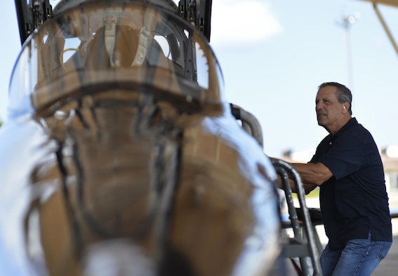 Retired Lt. Col. Dale Cooke, a former Air Force Thunderbird pilot, climbs a ladder to view the cockpit of his former T-38 Talon at Tyndall Air Force Base, Fla., Sept. 7, 2016. Cooke flew the T-38 from 1979-1982 when it was a Thunderbird jet and performed in over 200 events annually. (U.S. Air Force photo/Tech. Sgt. Javier Cruz)