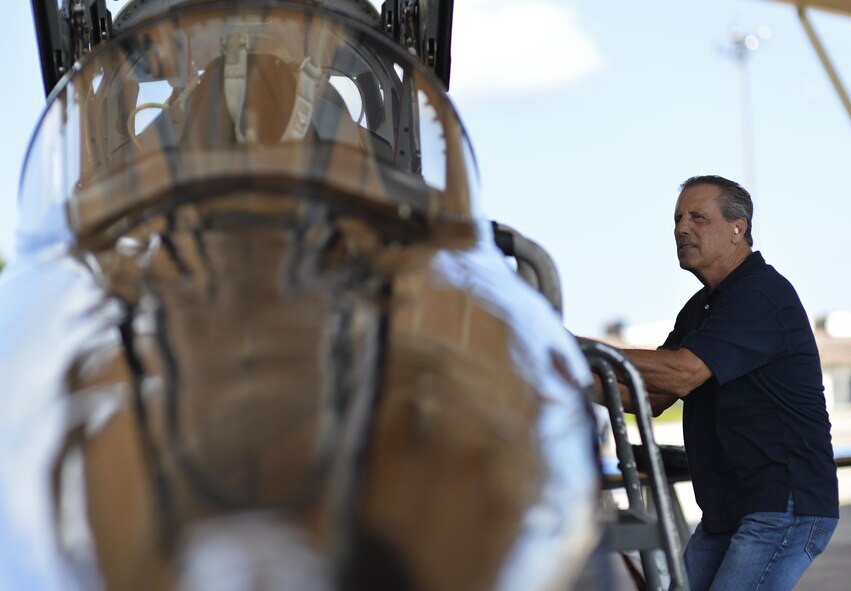 Retired Lt. Col. Dale Cooke, a former Air Force Thunderbird pilot, climbs a ladder to view the cockpit of his former T-38 Talon at Tyndall Air Force Base, Fla., Sept. 7, 2016. Cooke flew the T-38 from 1979-1982 when it was a Thunderbird jet and performed in over 200 events annually. (U.S. Air Force photo/Tech. Sgt. Javier Cruz)