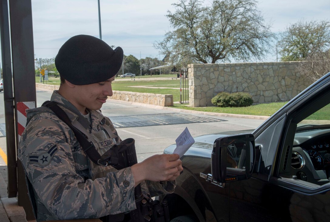 U.S. Air Force Airman 1st Class Brandon Melencio, 7th Security Forces Squadron member, checks a visitor’s pass at the Arnold Gate, March 22, 2016, at Dyess Air Force Base, Texas. Under the REAL ID Act, all federal and state identification must meet certain standards to ensure they are credible. More than 30 states and territories, including Texas, are not in compliance with the act and cardholders of those areas could soon face difficulty accessing military installations. (U.S. Air Force photo by Airman 1st Class Austin Mayfield)