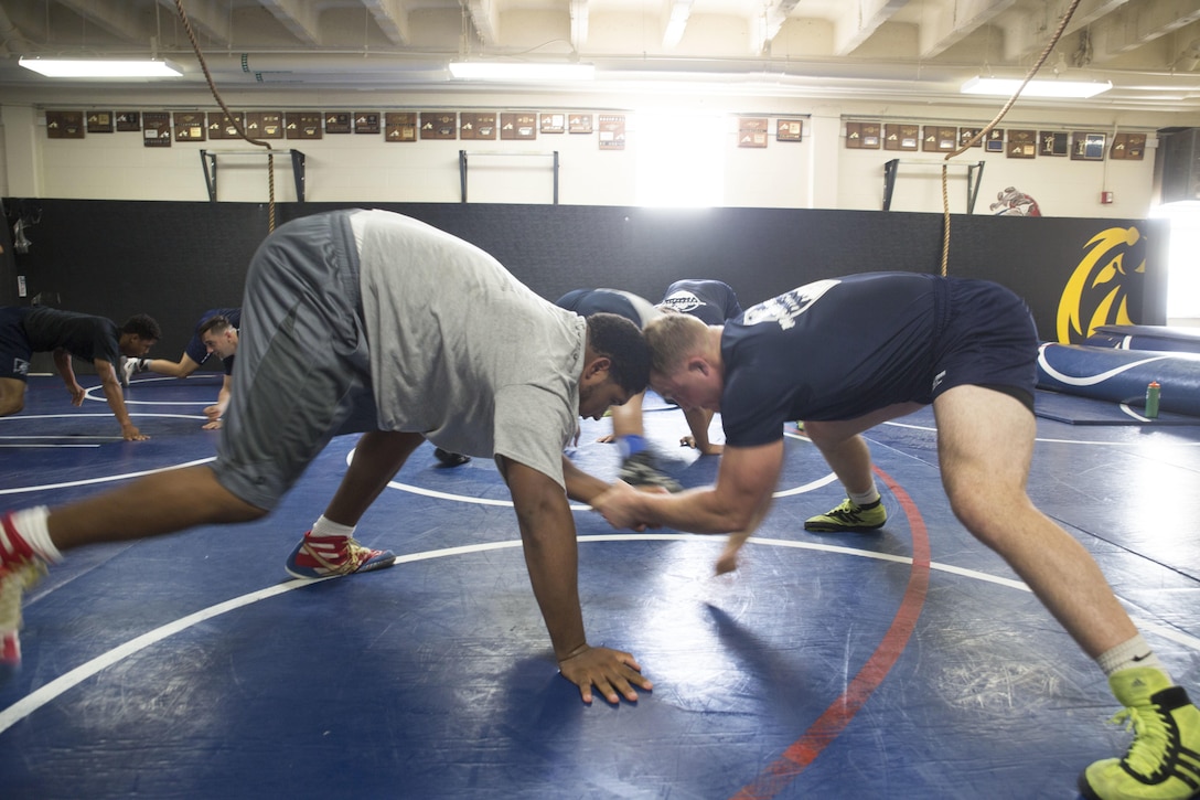 Lawrence Shelton practices different maneuvers with Cpl. Trent Osnes during a wrestling practice at McGavock High School in Nashville, Tenn. featuring the All-Marine Wrestling Team during Marine Week Nashville, Sept. 7, 2016. After practicing with the students, the Marines answered questions about wrestling and discussed the All-Marine Sports Program and the opportunities available to athletes in the Corps. More than 700 Marines are participating in Marine Week Nashville to give members of the community the opportunity to interact with individual Marines and celebrate community, country, and Corps. Shelton is a Nashville native and a Senior at McGavock High School. Osnes is a native of Valentine, Nebraska, and a Wrestler for the All-Marine Wrestling Team at Marine Corps Base Camp Lejeune, N.C.