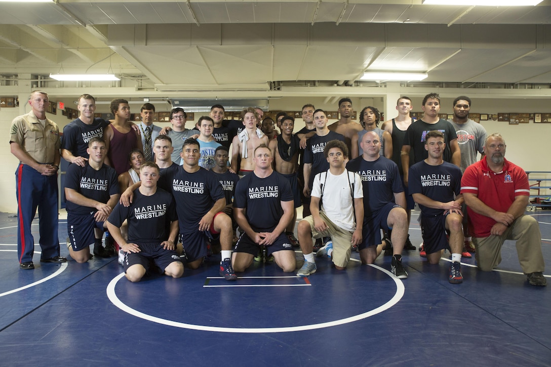 Wrestlers with the All-Marine Wrestling Team and the McGavock High School Wrestling Team pose for a photograph after practice during Marine Week Nashville, Sept. 7, 2016. After practicing with the students, the Marines answered questions about wrestling and discussed the All-Marine Sports Program and the opportunities available to athletes in the Corps. More than 700 Marines are participating in Marine Week Nashville to give members of the community the opportunity to interact with individual Marines and celebrate community, country, and Corps.