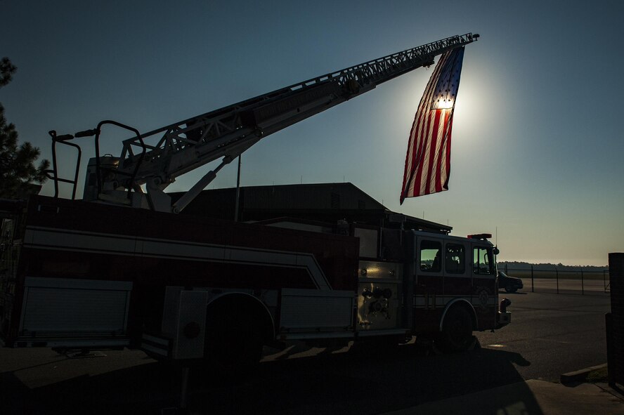 A U.S. flag hangs from a fire truck’s ladder during a 9/11 memorial ceremony, Sept. 11, 2016, at Moody Air Force Base, Ga. On the 15th anniversary of the attacks, people gathered at Moody’s fire department at 9:11 a.m. to pay tribute to the approximately 343 firefighters and paramedics, as well as 60 port authority and New York City police officers, who lost their lives while attempting to rescue the 2,945 victims that perished. (U.S. Air Force photo by Airman 1st Class Daniel Snider) 