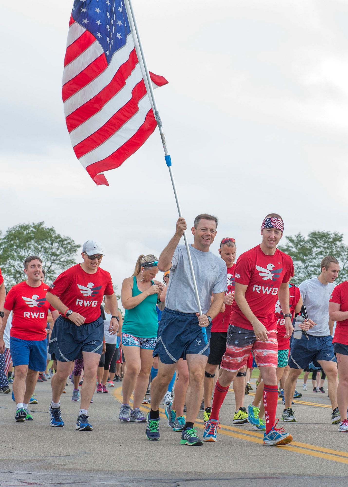 U.S. Air Force Col. Bradley McDonald, 88th Air Base Wing commander holds the U.S. flag during the Run for the Fallen on Area B flight line at Wright-Patterson Air Force Base, Ohio, September 9, 2016.  The Run for the Fallen provides an opportunity to remember and honor those who lost their lives and recognize those who continue to defend the nation. (U.S. Air Force photo by Michelle Gigante)