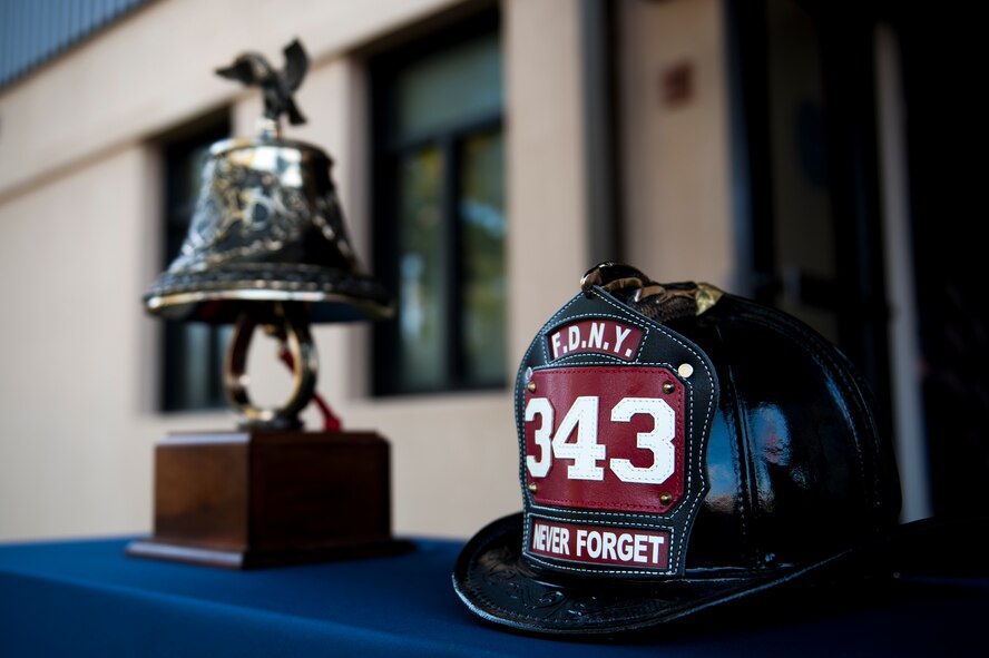 A firefighter’s helmet representing the 343 firefighters lost on 9/11 rests next to a ceremonial bell during a 9/11 memorial ceremony, Sept. 11, 2016, at Moody Air Force Base, Ga. During the ceremony, members also paid tribute to all who’ve served Moody’s fire department and passed away. (U.S. Air Force Photo by, Airman 1st Class Daniel Snider)