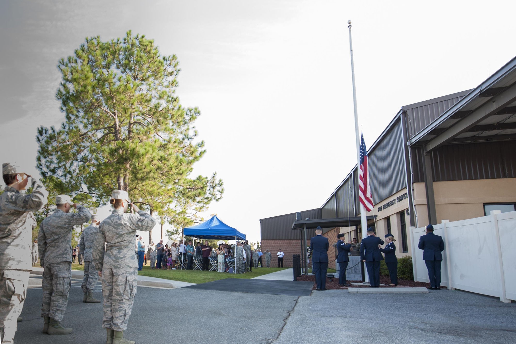 Team Moody shows their respect while a U.S. flag is placed at half-staff during a 9/11 memorial ceremony, Sept. 11, 2016, at Moody Air Force Base, Ga. On Sept. 11, 2001, terrorists simultaneously hijacked four passenger jets flying two into the World Trace Center located in New York City, one into the Pentagon and one crashing in Stonycreek Township, Pennsylvania. (U.S. Air Force photo by Airman 1st Class Daniel Snider)