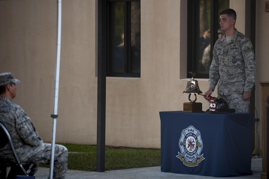 U.S. Air Force Airman 1st Class Nicholas Gough, 23d Civil Engineer Squadron firefighter, rings a ceremonial firefighter’s bell during a 9/11 memorial ceremony, Sept. 11, 2016, at Moody Air Force Base, Ga. As firefighter tradition, three rings represent honor and respect for those who have given their lives while serving others. (U.S. Air Force photo by Airman 1st Class Daniel Snider)