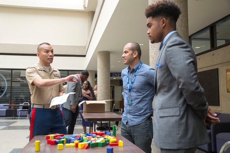 Capt. Yuwynn Ho discusses different leadership styles with Mehmet Sugut and Alex Hill during the Marine Corps Leadership Seminar held at Tennessee State University as part of Marine Week Nashville, Sept. 7, 2016. The seminar provides the Marine Corps with an opportunity to communicate a message of leadership and integrity and the opportunities the Marine Corps provides to a diverse population of students. Marine Week provides the opportunity for Marines to commemorate the unwavering support of the American people, and share their story of the Marines to a city that doesn't have opportunities to interact with Marines on a regular basis. Ho is a Ground Operations Officer, Central Command. Sugut is a Nashville native and Masters in Business and Administration Student at TSU. Sugut is a Nashville native and Masters in Business and Administration student at TSU. Hill is a Nashville native and Sophomore at TSU.