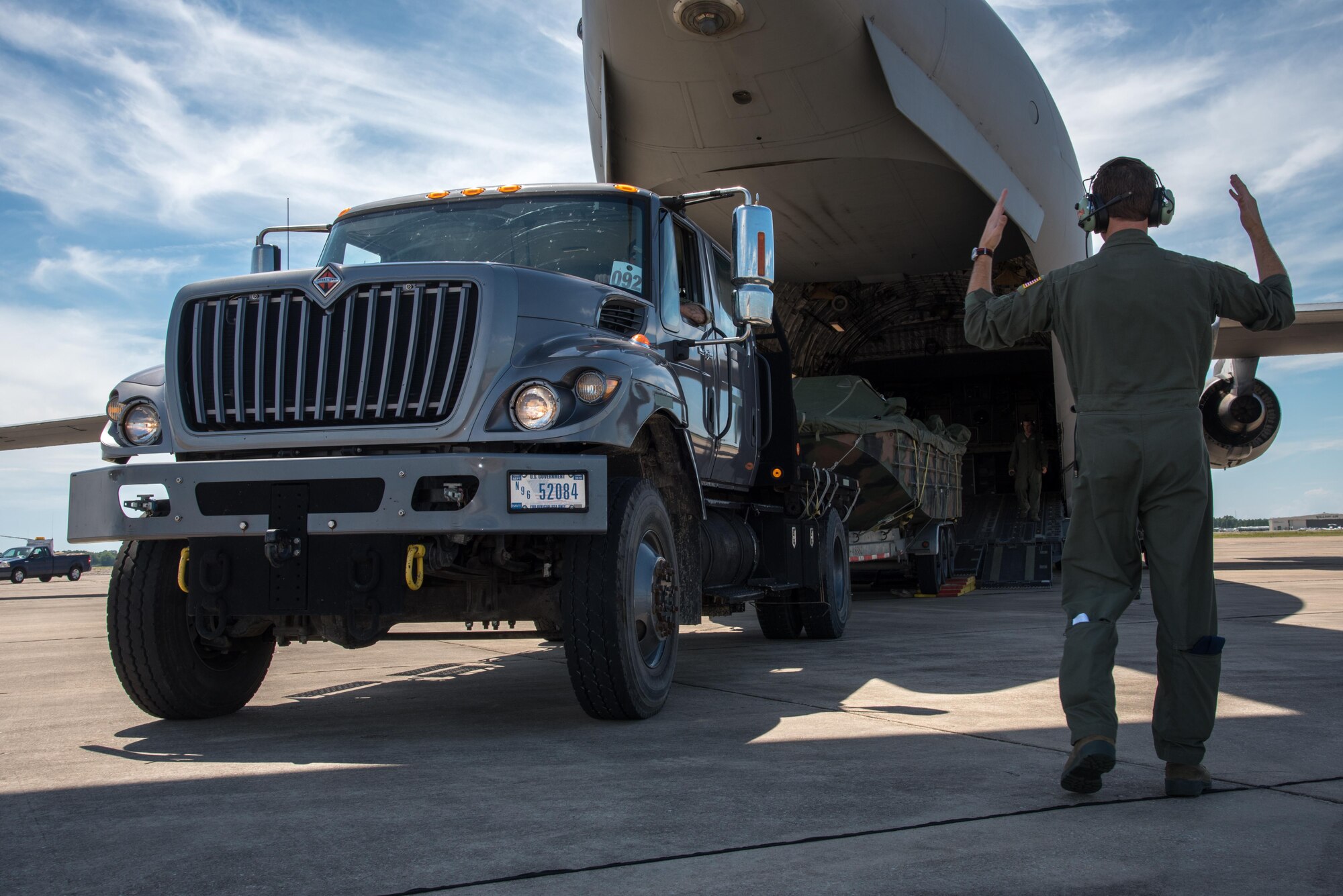 A member of the 315th Airlift Wing directs a naval boat onto a C-17 Globemaster III during a joint training exercise named Patriot Mustang GRIP II. The exercise was conducted with members of the Air Force Reserve's 41st Aerial Port Squadron as well as Army and Navy members from along the Gulf Coast Sept. 9-10 at Stennis International Airport. (U.S. Air Force photo/Staff Sgt. Shelton Sherrill) 