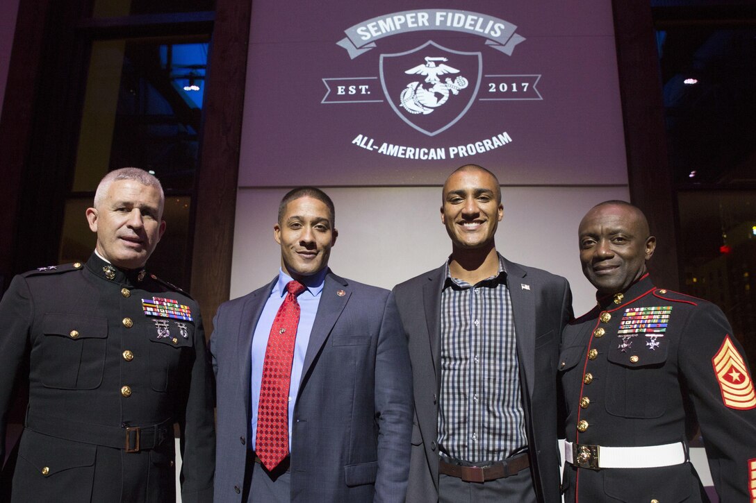 Major Gen. Paul Kennedy, Verice Bennett, Ashton Eaton, and Sgt. Maj. Samuel Heyward Jr. pose for a photograph after announcing a new Marine Corps Recruiting Command initiative called the Semper Fidelis All-American Program during a banquet at The Bell Tower in Nashville, Tenn., Sept. 9, 2016. The new program is an evolution of the previously executed Semper Fidelis Football Program, which will send one man and woman from each of the Marine Corps’ 48 Recruiting Stations to the Battles Won Academy in Washington D.C. where they will earn the title Semper Fidelis All-American, next summer. For more information on the Semper Fidelis All-American Program and its Battles Won Academy, please visit sfaap.marines.com. The banquet was a part of Marine Week, a celebration of Community, Country and Corps that allows the public to learn about the Corps through hands-on static displays, live demonstrations, time-honored Marine Corps traditions, musical performances and more. Kennedy is the Commanding General of MCRC. Bennett is a retired first sergeant in the Marine Corps, and a Silver Star recipient for his actions in Afghanistan. Eaton is an American decathlete, two-time Olympic champion and a world record holder in both the decathlon and indoor heptathlon events. Heyward Jr. is the Sergeant Major of MCRC.
