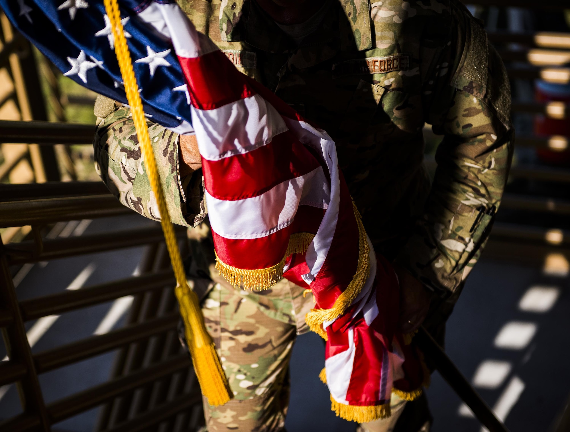 An Airman carries an American flag up a flight of stairs during a 9/11 Memorial Stair Climb event held at Duke Field, Fla., Sept. 10.  The 24-hour climb began at 8:46 a.m. with the 919th Special Operations Wing commander walking the flag up the outside stairwell of the base’s billeting facility.  Wing Airmen took turns walking the flag up and down the stairwell the entire day until it was delivered to a firefighter and security forces color guard at 8:46 a.m. the next morning for a 9/11 Remembrance ceremony. More than 115 Airmen carried the flag throughout the day and night for a total of more than 207,000 steps. (U.S. Air Force photo/Tech. Sgt. Sam King)