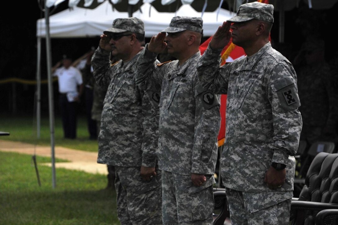 Command Sgt. Maj. Harry Munoz, Brig. Gen. Alberto C. Rosende, and Command Sgt. Maj. Orlando Santiago salute the Colors as the National Anthem is played during the 1st Mission Support Command Change of Responsibility Ceremony, September 10 at the Maxi Williams Field on Fort Buchanan, Puerto Rico.