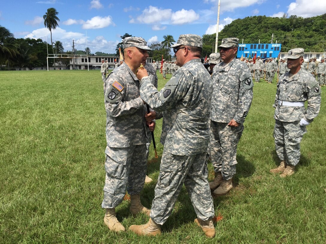 Command Sgt. Maj. Harry Muñoz relinquishes responsibility and authority of the 1st Mission Support Command to Command Sgt. Maj. Orlando Santiago during the 1st Mission Support Command Change of Responsibility Ceremony, September 10 at the Maxi Williams Field on Fort Buchanan, Puerto Rico.