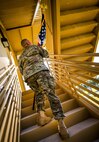 An Airman carries an American flag up a flight of stairs during a 9/11 Memorial Stair Climb event held at Duke Field, Fla., Sept. 10.  The 24-hour climb began at 8:46 a.m. with the 919th Special Operations Wing commander walking the flag up the outside stairwell of the base’s billeting facility.  Wing Airmen took turns walking the flag up and down the stairwell the entire day until it was delivered to a firefighter and security forces color guard at 8:46 a.m. the next morning for a 9/11 Remembrance ceremony. More than 115 Airmen carried the flag throughout the day and night for a total of more than 207,000 steps. (U.S. Air Force photo/Tech. Sgt. Sam King)