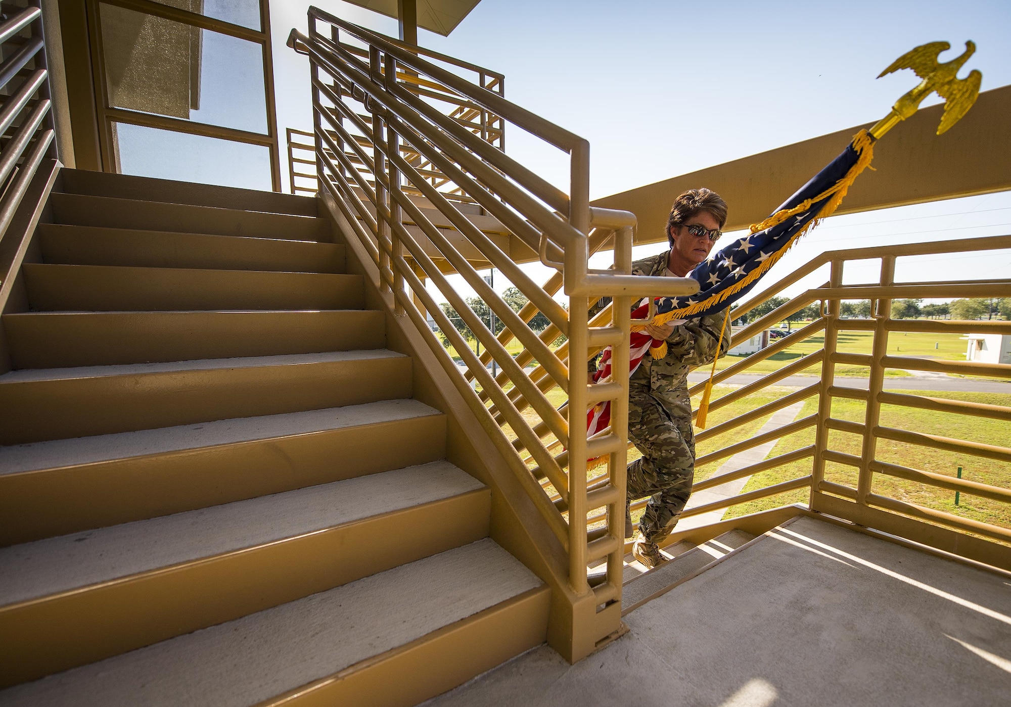 Master Sgt. Stacey Jackowiak, 919th Special Operations Security Forces Squadron, carries an American flag up a flight of stairs during a 9/11 Memorial Stair Climb event held at Duke Field, Fla., Sept. 10.  The 24-hour climb began at 8:46 a.m. with the 919th Special Operations Wing commander walking the flag up the outside stairwell of the  base’s billeting facility.  Wing Airmen took turns walking the flag up and down the stairwell the entire day until it was delivered to a firefighter and security forces color guard at 8:46 a.m. the next morning for a 9/11 Remembrance ceremony.  More than 115 Airmen carried the flag throughout the day and night for a total of more than 207,000 steps.  (U.S. Air Force photo/Tech. Sgt. Sam King)