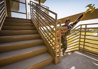 Master Sgt. Stacey Jackowiak, 919th Special Operations Security Forces Squadron, carries an American flag up a flight of stairs during a 9/11 Memorial Stair Climb event held at Duke Field, Fla., Sept. 10.  The 24-hour climb began at 8:46 a.m. with the 919th Special Operations Wing commander walking the flag up the outside stairwell of the  base’s billeting facility.  Wing Airmen took turns walking the flag up and down the stairwell the entire day until it was delivered to a firefighter and security forces color guard at 8:46 a.m. the next morning for a 9/11 Remembrance ceremony.  More than 115 Airmen carried the flag throughout the day and night for a total of more than 207,000 steps.  (U.S. Air Force photo/Tech. Sgt. Sam King)