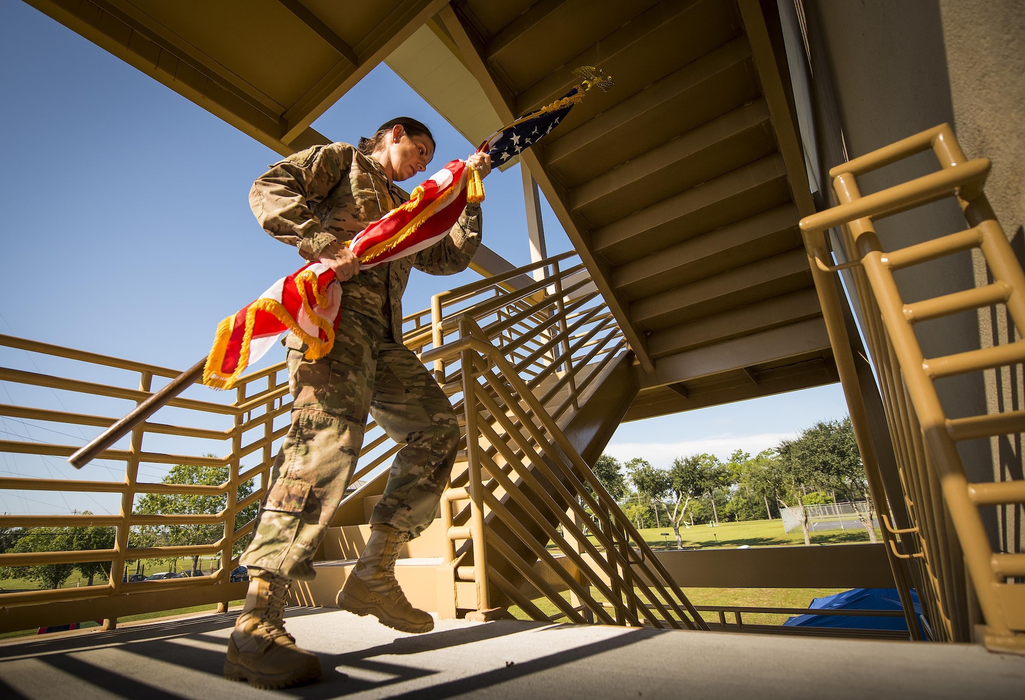 Master Sgt. Leslie Lovegrove, 711th Special Operations Squadron, carries an American flag up a flight of stairs during a 9/11 Memorial Stair Climb event held at Duke Field, Fla., Sept. 10.  The 24-hour climb began at 8:46 a.m. with the 919th Special Operations Wing commander walking the flag up the outside stairwell of the base’s billeting facility.  Wing Airmen took turns walking the flag up and down the stairwell the entire day until it was delivered to a firefighter and security forces color guard at 8:46 a.m. the next morning for a 9/11 Remembrance ceremony. More than 115 Airmen carried the flag throughout the day and night for a total of more than 207,000 steps. (U.S. Air Force photo/Tech. Sgt. Sam King)