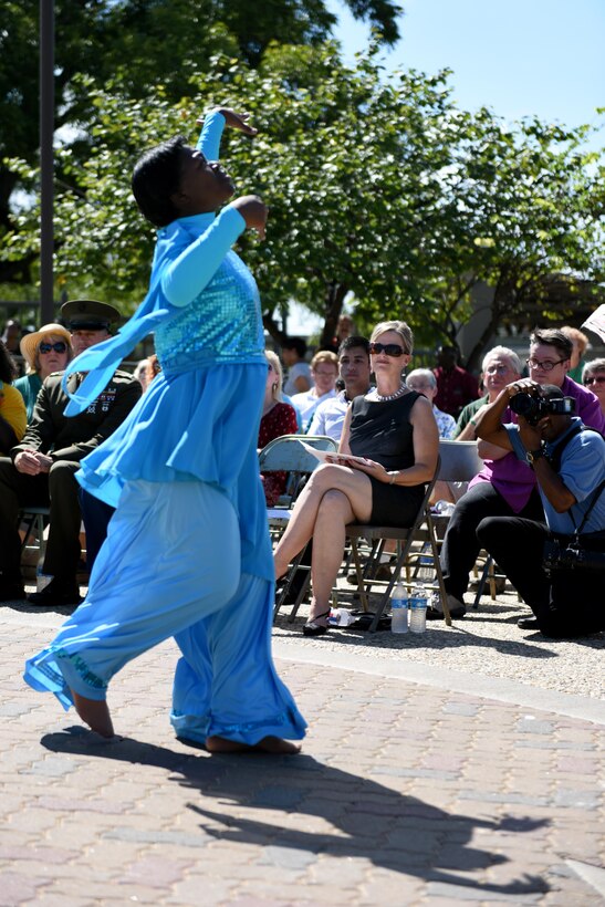 Leah Downs, Goodfellow Air Force Base key spouse, watches Tamara Pope dance during the San Angelo 9/11 Remembrance Ceremony at the Fine Arts Museum in San Angelo, Texas, Sept. 11, 2016. Pope danced to ‘Peace in the Valley’ to represent Generation X’s presentation of peace to the victims of the attacks of 9/11. (U.S. Air Force photo by Airman 1st Class Caelynn Ferguson/Released)