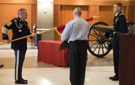 Command Sgt. Maj. (Retired) Joseph Haddad and Command Sgt. Maj. (Retired) Kyle Russell present the one-star flag to Brig. Gen. Miles Davis during his promotion ceremony on September 11, 2016 at the National Infantry Museum at Fort Benning. Haddad and Russell both formerly served as command sergeant major for Davis at the battalion and brigade levels respectively.