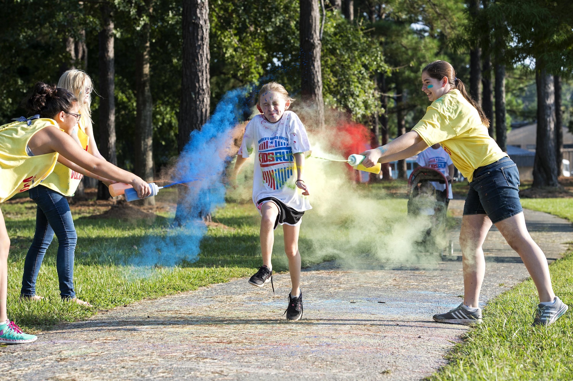 A participant runs through a ‘splash zone’ during a Kid’s Color Run, Sept. 20, 2016, at Moody Air Force Base, Ga. More than 150 runners participated in the run which was designed to get kids to exercise in a family friendly event. (U.S. Air Force photo by Airman 1st Class Janiqua P. Robinson)