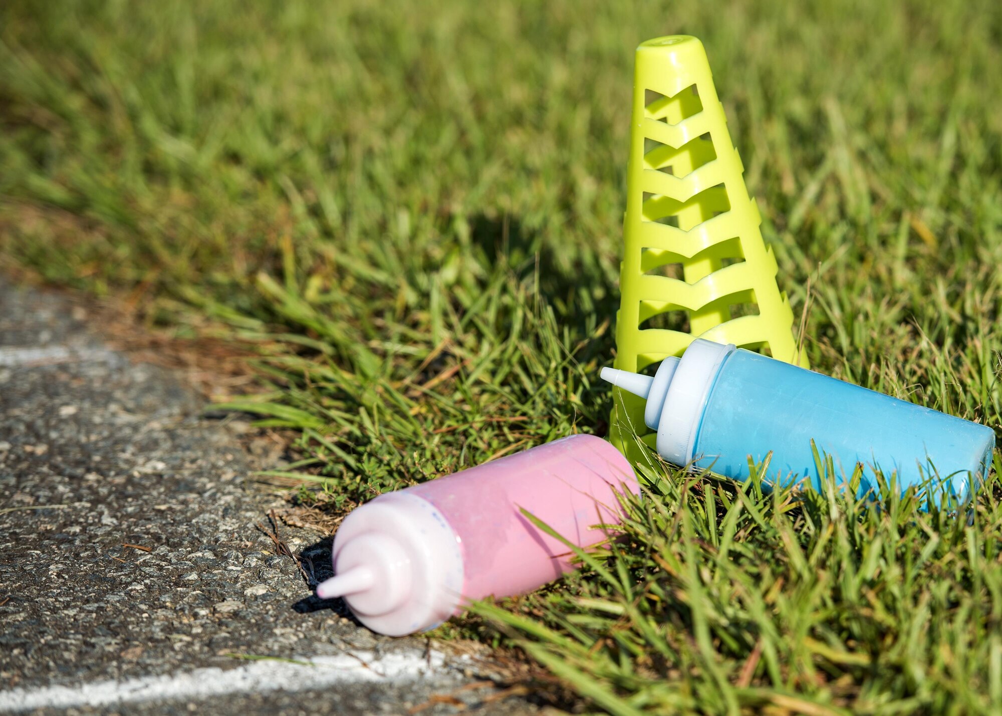 Chalk dispensers rest on the ground during a Kid’s Color Run, Sept. 10, 2016, at Moody Air Force Base, Ga. Participants were colored with scented chalk as they ran through various ‘splash zones’. (U.S. Air Force photo by Airman 1st Class Janiqua P. Robinson)