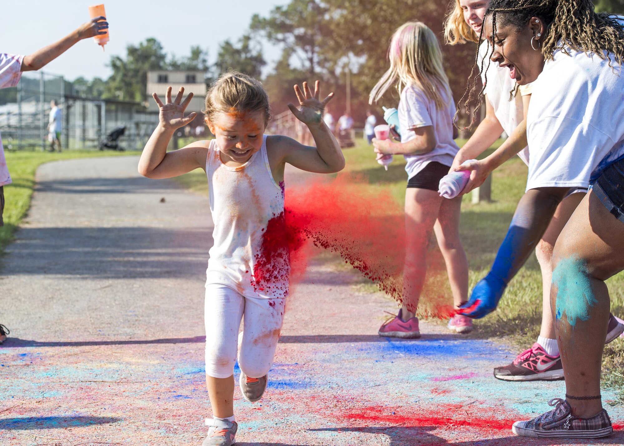 A participant runs through a ‘splash zone’ during a Kid’s Color Run, Sept. 10, 2016, at Moody Air Force Base, Ga.  Moody Youth Programs is slated to host a Go Pink Color Run for their girl power initiative in conjunction with Breast Cancer Awareness Month in October. (U.S. Air Force photo by Airman 1st Class Janiqua P. Robinson)