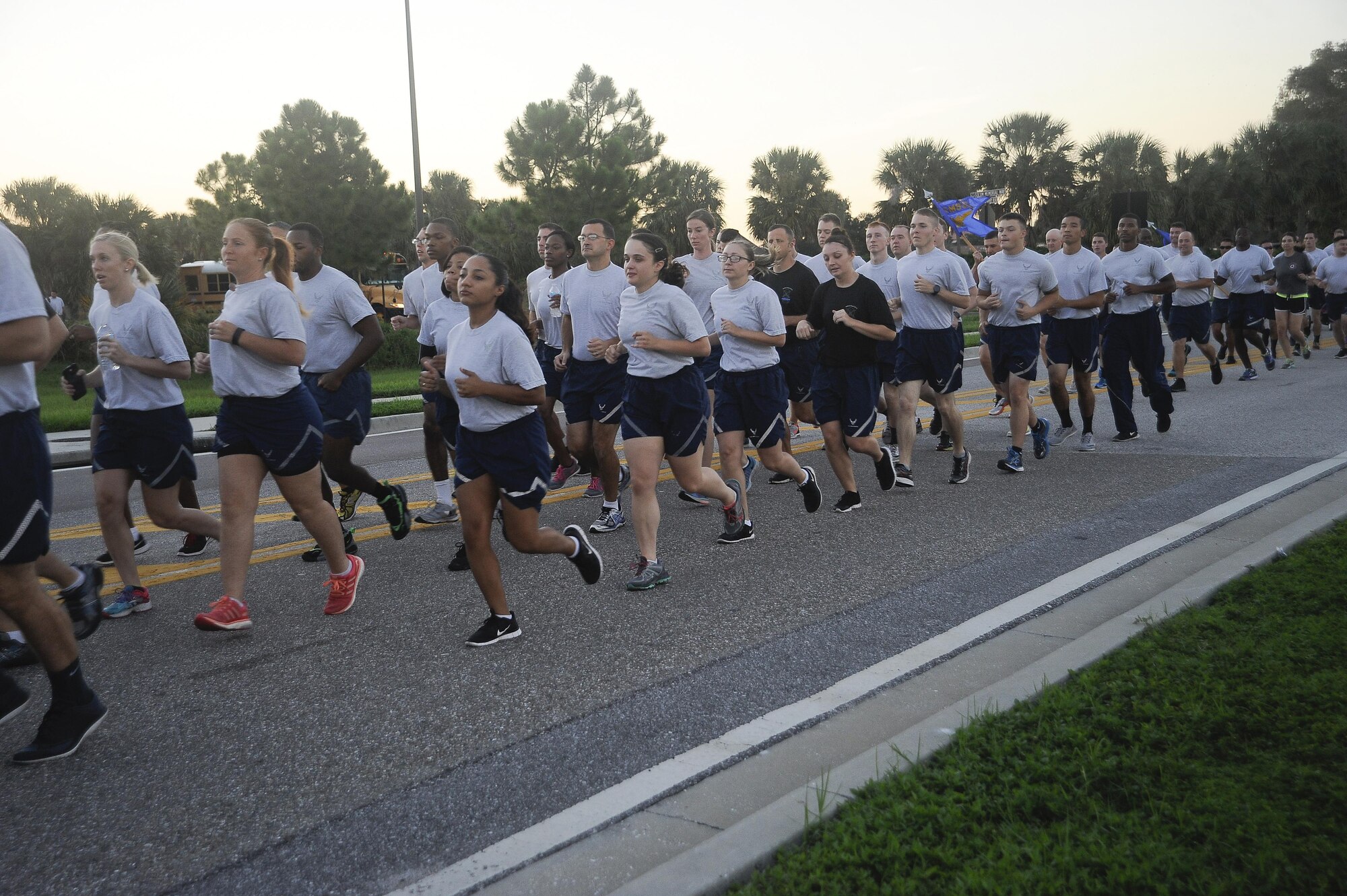 Members of Team MacDill run in formation during the 6th Annual Helton Haul Memorial Run at MacDill Air Force Base, Fla., Sept. 8, 2016. The run started and ended at Helton Hall, the 6th Security Forces Squadron building, named after a fallen MacDill Airman, 1st Lt. Joseph D. Helton. (U.S. Air Force photo by Airman 1st Class Mariette Adams)