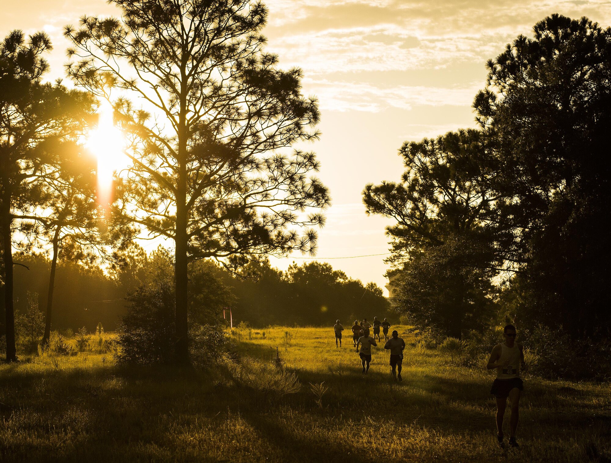 Airmen begin the 9/11 Memorial 6k trail run at sunrise Sept. 11 at Duke Field, Fla.  About 100 Airmen and families participated in the run.  Along the path, there were remembrance signs of fallen Air Force special operators who lost their lives after 9/11.  (U.S. Air Force photo/Tech. Sgt. Sam King)