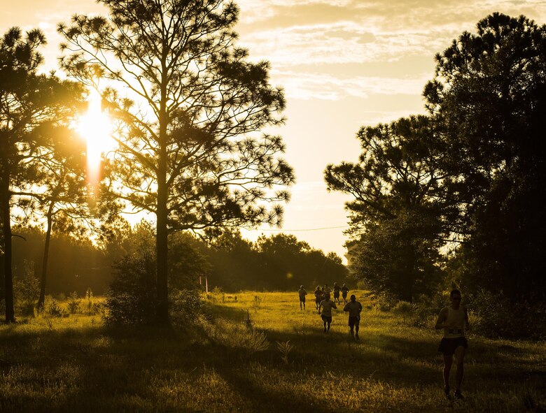 Airmen begin the 9/11 Memorial 6k trail run at sunrise Sept. 11 at Duke Field, Fla.  About 100 Airmen and families participated in the run.  Along the path, there were remembrance signs of fallen Air Force special operators who lost their lives after 9/11.  (U.S. Air Force photo/Tech. Sgt. Sam King)