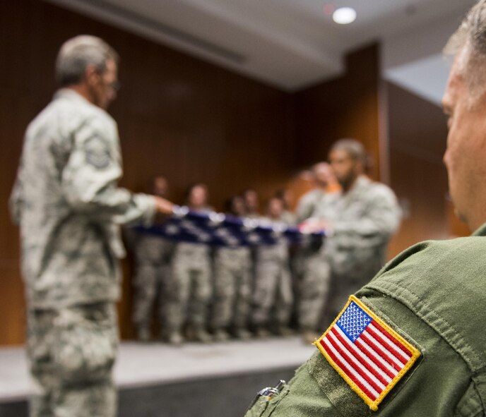 Chief Master Sgt. Tyler Outten, 919th Special Operations Group, watches a flag-folding service at the 9/11 Memorial Ceremony Sept. 11 at Duke Field, Fla.  During the ceremony, Airmen took time to remember the tragic events and pay their respects to those who lost their lives.   (U.S. Air Force photo/Tech. Sgt. Sam King)