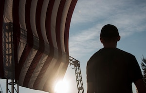 Austin Scott, Prince George’s County Fire and Emergency Medical Services Department firefighter, faces the American flag during the 2016 National Capital Region 9/11 Memorial Stair Climb and 5K Walk at the Gaylord National Resort and Convention Center at National Harbor, Md., Sept. 10, 2016. The event, hosted by the National Fallen Firefighters Foundation, brought attendees from local counties and military bases to either climb a total of 110 flights of stairs or walk a 5K in honor of the 343 firefighters who lost their lives in the terrorist attacks on Sept. 11, 2001. (U.S. Air Force photo by Airman 1st Class Valentina Lopez)