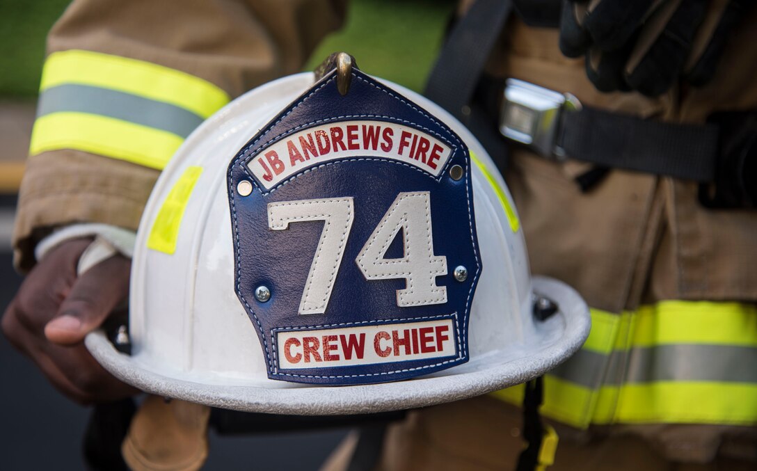 A Joint Base Andrews Fire Department firefighter crew chief holds a helmet during the 2016 National Capital Region 9/11 Memorial Stair Climb and 5K Walk at the Gaylord National Resort and Convention Center at National Harbor, Md., Sept. 10, 2016. Approximately 21 military members from the Joint Base Andrews Fire Department and 11th Security Forces Squadron attended the event to climb 110 flights of stairs in honor of the 343 who made the ultimate sacrifice due to the terrorist attacks on Sept. 11, 2001. (U.S. Air Force photo by Airman 1st Class Valentina Lopez)
