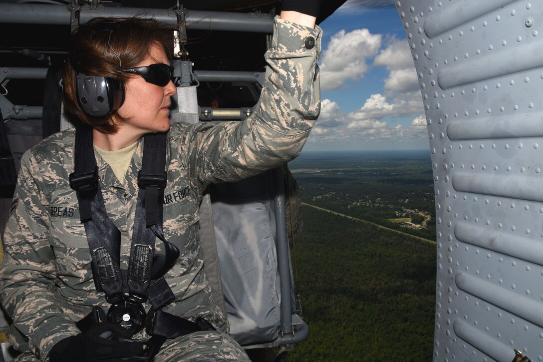 Airman First Class Michelle Speas, 41st Aerial Port Squadron air transportation specialist , looks out at the view from a UH-60 Blackhawk during joint training mission Patriot Mustang GRIP II (Guard Reserve Inspiring Patriots). The team of aerial porters were flown from Gulfport Regional Airport to Stennis International Airport by the 1108th Theater Sustainment Maintenance Group as part of the mission. (U.S. Air Force photo/Staff Sgt. Nicholas Monteleone)