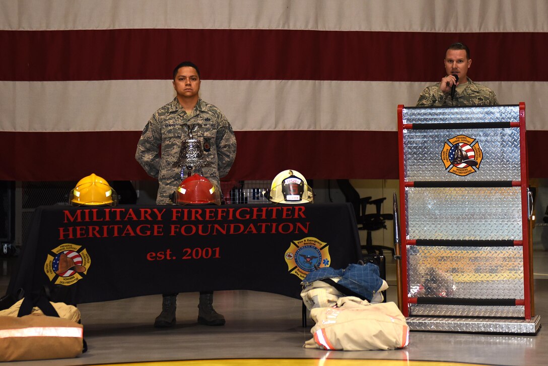 U.S. Air Force Tech. Sgt. Roy Campos, 312th Training Squadron instructor, and Tech. Sgt. Kyle Dobler, 312th TRS instructor, present a 9/11 remembrance ceremony for 312th TRS students at the Louis F. Garland Department of Defense Fire Academy high bay on Goodfellow Air Force Base, Texas, Sept. 9, 2016. Campos and Dobler rang a ceremonial bell to honor fallen comrades during 9/11 and gave a 10-minute speech to the 312th TRS students before classes began. (U.S. Air Force photo by Airman 1st Class Caelynn Ferguson/Released)