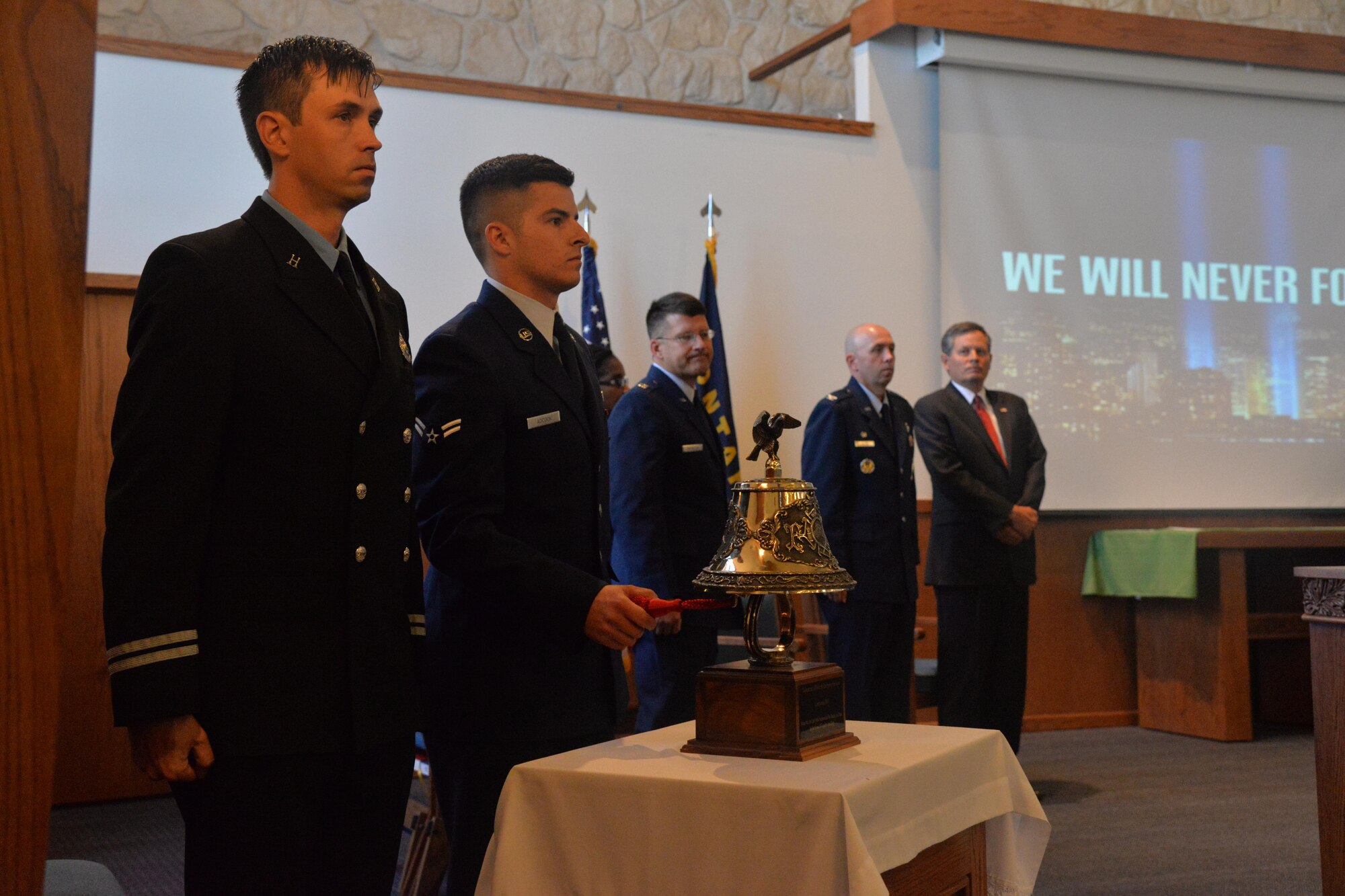 Airman 1st Class Matthew Adcock, 341st Civil Engineer Squadron firefighter, rings a bell during the 9/11 Remembrance ceremony Sept. 9, 2016, at Malmstrom Air Force Base, Mont. The ringing of the bell symbolizes the end of the duty day for the firemen who lost their lives on Sept. 11, 2001. (U.S. Air Force photo/Airman 1st Class Daniel Brosam)