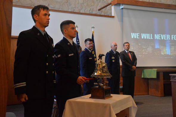 Airman 1st Class Matthew Adcock, 341st Civil Engineer Squadron firefighter, rings a bell during the 9/11 Remembrance ceremony Sept. 9, 2016, at Malmstrom Air Force Base, Mont. The ringing of the bell symbolizes the end of the duty day for the firemen who lost their lives on Sept. 11, 2001. (U.S. Air Force photo/Airman 1st Class Daniel Brosam)