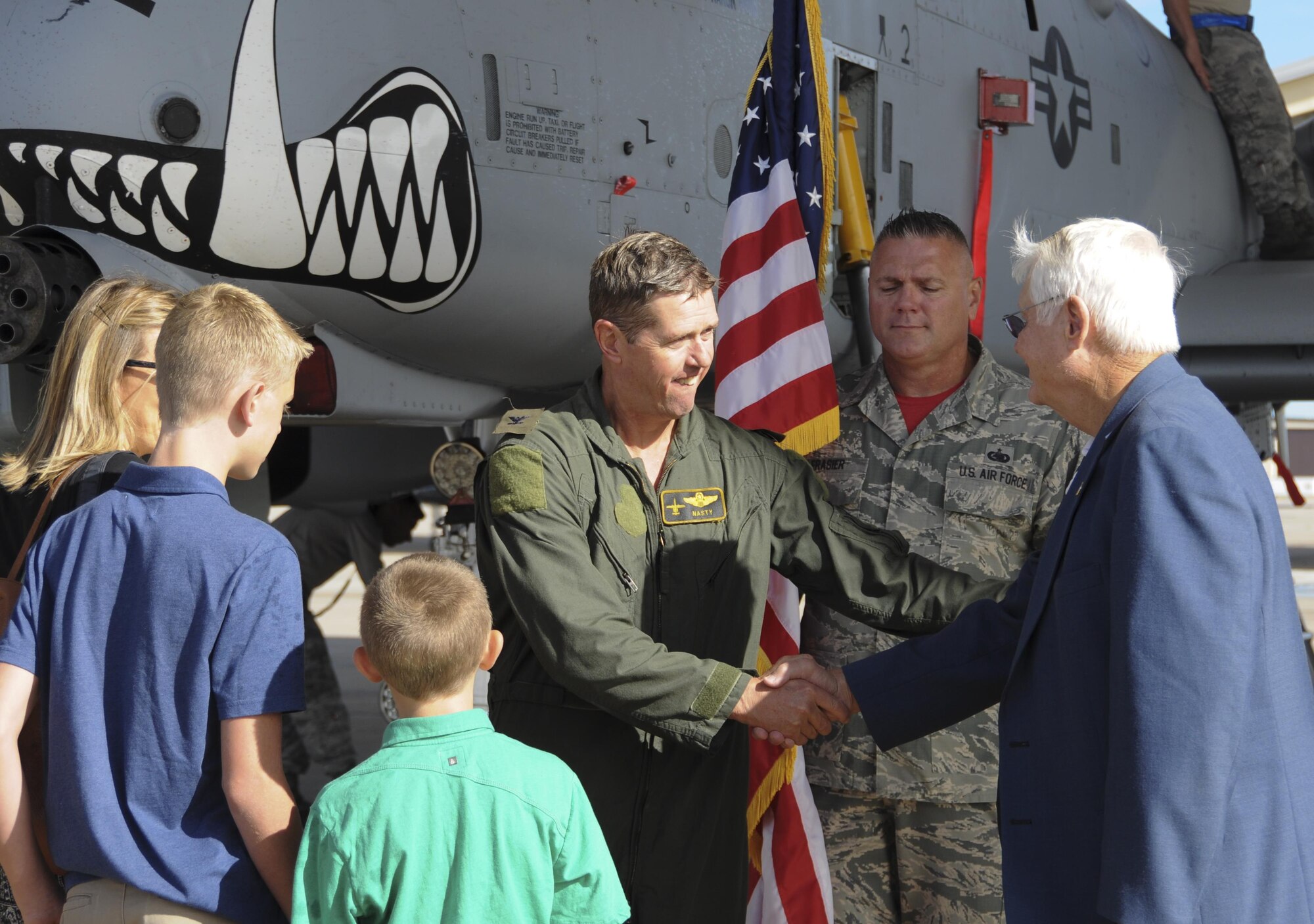 Col. Stephen Nester shakes hands with his father, a retired Air Force general, after his final flight with the 303rd Fighter Squadron and promotion ceremony on Sept. 10, 2016, at Whiteman Air Force Base, Mo. Nester has deployed in support of multiple operations including Deny Flight, Southern Watch, Northern Watch, Operation Iraqi Freedom, and Operation Enduring Freedom. (U.S. Air Force photo/Senior Airman Missy Sterling)