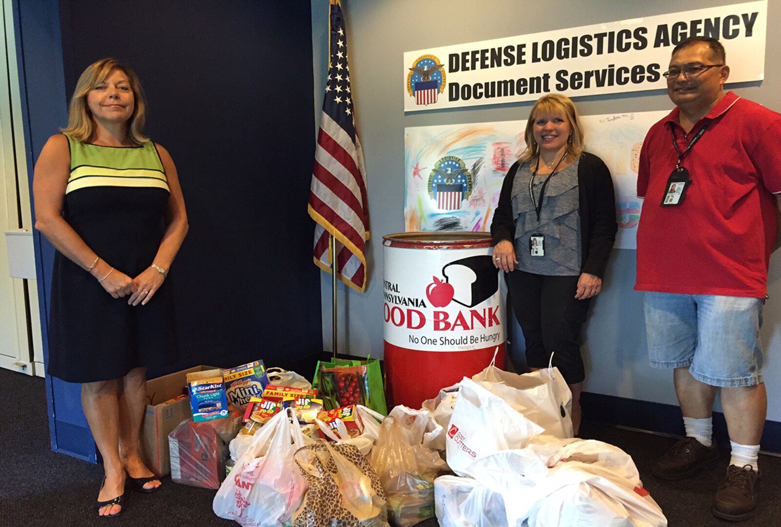 Three individual DLA offices recently combined their efforts for the recently concluded Feds Feed Families campaign. (From left) Chris Shardt, DLA Document Services; Michele Hippensteel, DLA Maritime Mechanicsburg; and Severino (Allan) Coronacion, DLA Disposition.