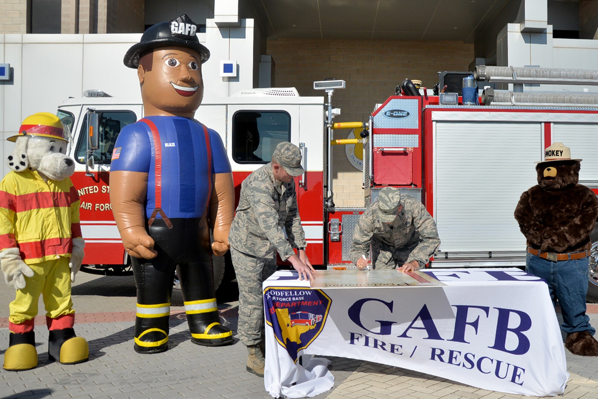 U.S. Air Force Col. Michael Downs, 17th Training Wing Commander, signs a Fire Prevention Week proclamation at the Norma Brown building on Goodfellow Air Force Base, Texas, Sept. 12, 2016. Downs proclaimed the second week of October 2016 as Fire Prevention Week. Fire Prevention Week commemorates the Great Chicago Fire of 1871, which killed more than 250 people, left 100,000 homeless and destroyed more than 17,400 buildings. (U.S. Air Force photo by Airman 1st Class Randall Moose/Released)