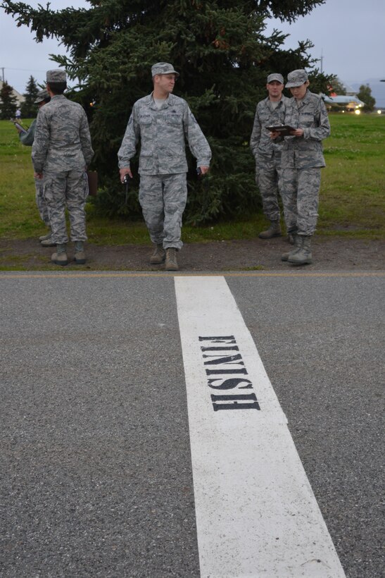 Air Force Master Sgt. Travis Schlapbach, 477th Fighter Group Maintenance Squadron, monitors an Air Force fitness assessment during the group's September Unit Training Assembly at Joint Base Elmendorf-Richardson, Alaska. (US Air Force photo by Maj. Barbara Jensen.)