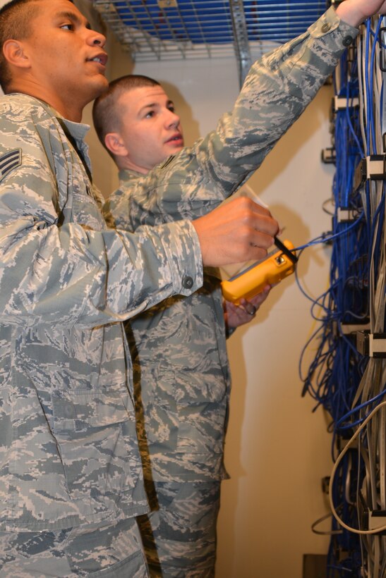 Air Force Senior Airman Demetrius Williams and Airman First Class Taylor Ellibee check communication equipment at the 477th Fighter Group during September's unit training assembly. The communications flight ensures the continuous security, operational availability and reliability of systems and equipment supporting the group's mission.