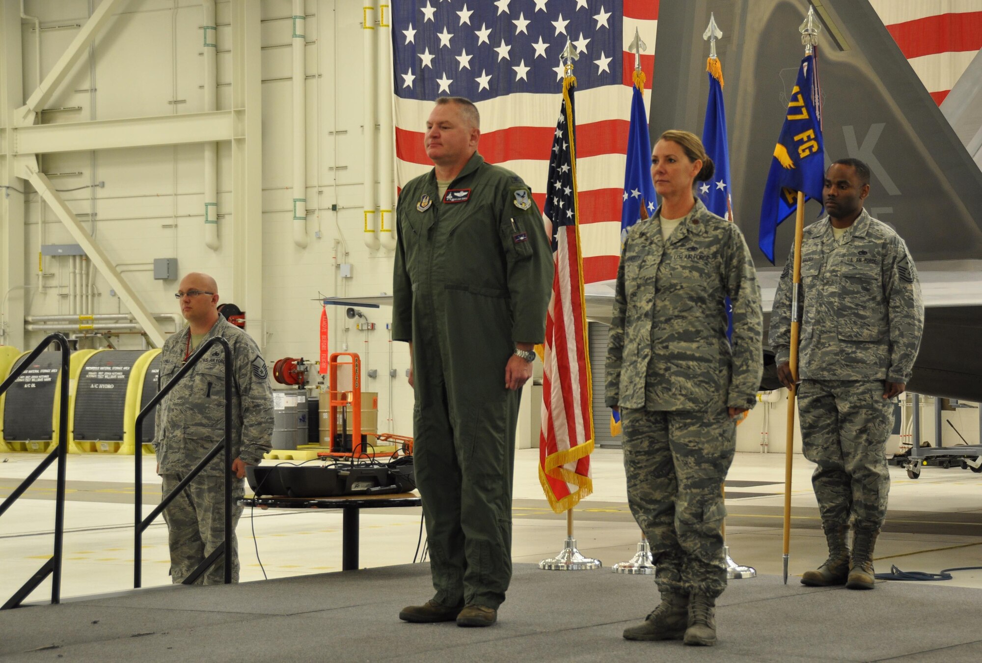 Air Force Col. Christopher Ogren, 477th Fighter Group Commander, presents the 477th Aircraft Maintenance Squadron colors to Maj. Rebecca Daugherty, the new 477th AMXS Commander, during an assumption of command ceremony at Joint Base Elmendorf-Richardson Sept. 11, 2016. (U.S. Air Force photo/Maj. Carla Gleason)