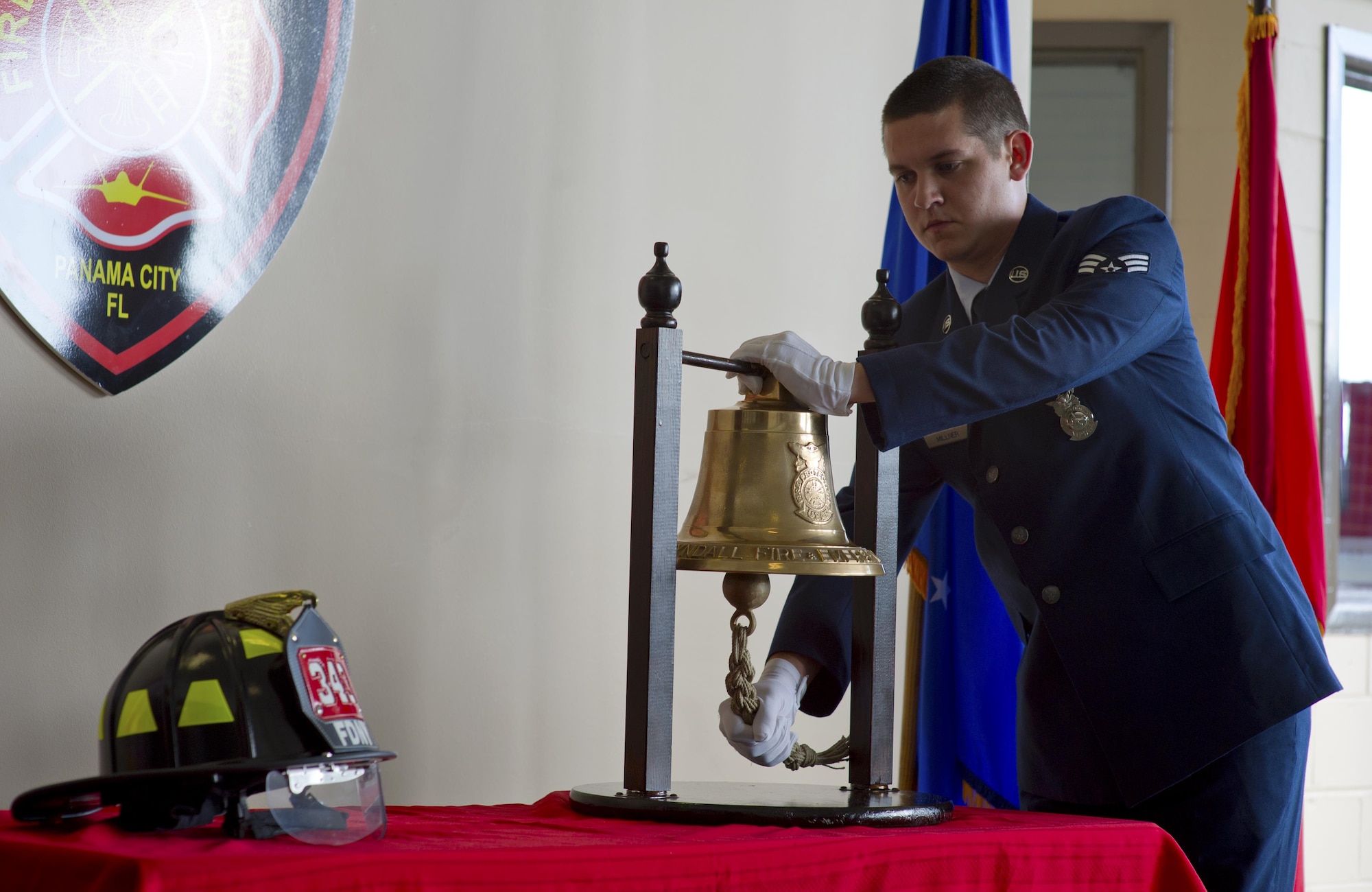U.S. Air Force Senior Airman Brian Millner, 325th Civil Engineer Squadron firefighter, rings the bell during the 9/11 Remembrance Ceremony at Tyndall’s Fire Station 1, Tyndall Air Force Base, Fla., Sept. 11, 2016. The ringing of the bell is a tradition signifies the end of a shift for a fallen firefighter. (U.S. Air Force photo by Staff Sgt. Alex Fox Echols III/Released)
